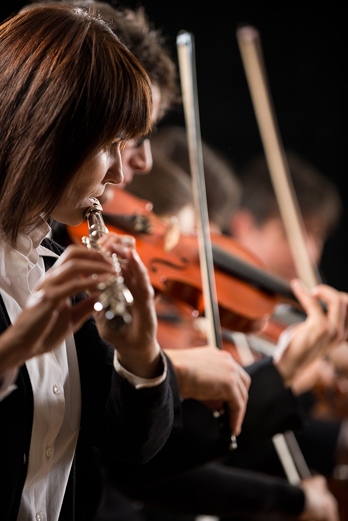 musician playing flute during performance