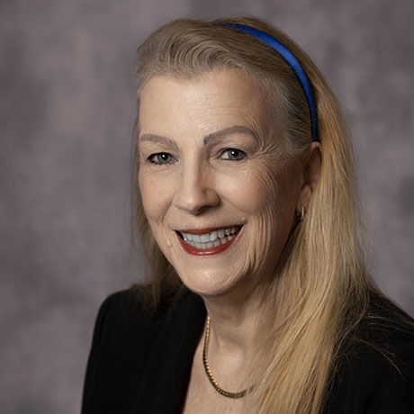Head and shoulders image of a smiling woman with long blonde hair.